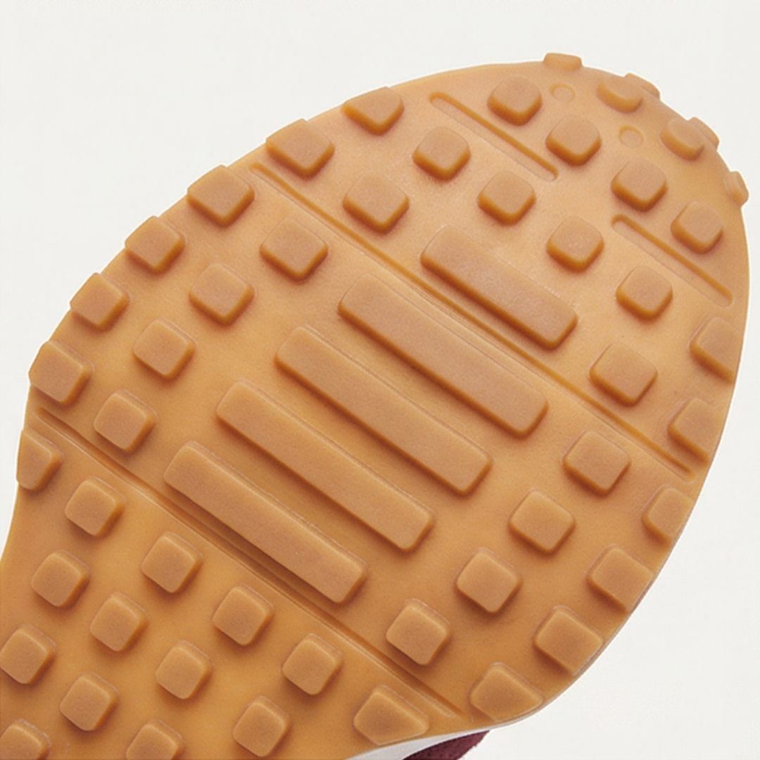 Close up of the tan rubber outsole tread of a retro suede sneaker