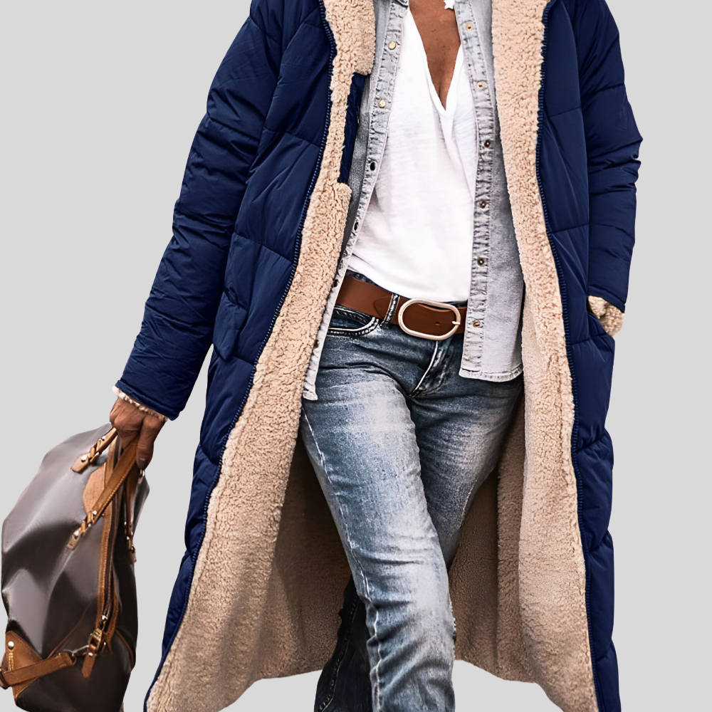 Navy quilted longline coat worn open, showing the cream sherpa lining and pockets