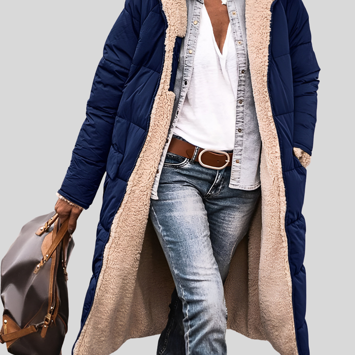Navy quilted longline coat worn open, showing the cream sherpa lining and pockets