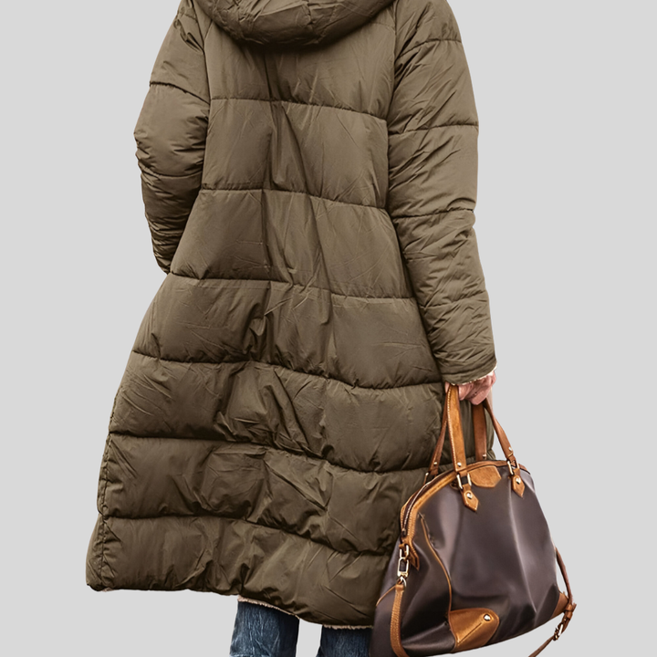Back view of the olive quilted longline hooded coat worn with a leather bag