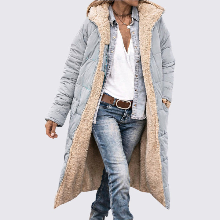 Light grey quilted longline coat worn open, showing the cream sherpa lining and front pockets