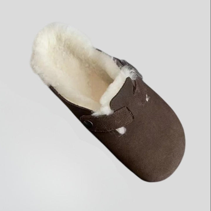 Single brown suede clog with cream shearling lining and buckle strap, top view