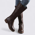 Dark brown knee high boots with side zip and block heel, worn with jeans