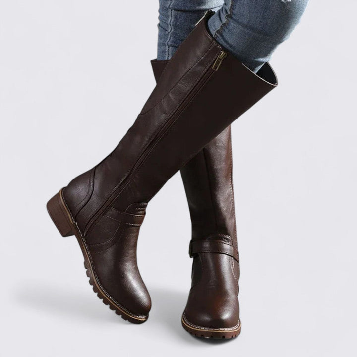 Dark brown knee high boots with side zip and block heel, worn with jeans