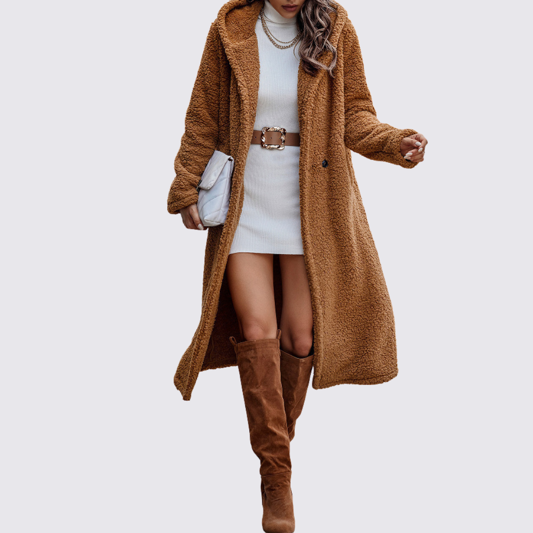Camel teddy fleece coat in a long cut, worn open over a white knit dress