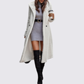 Cream teddy fleece longline coat worn open over a gray dress