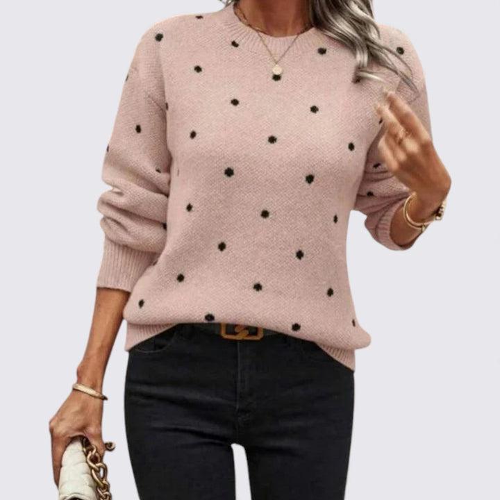 Blush pink crew neck sweater with small black polka dots, worn with black jeans