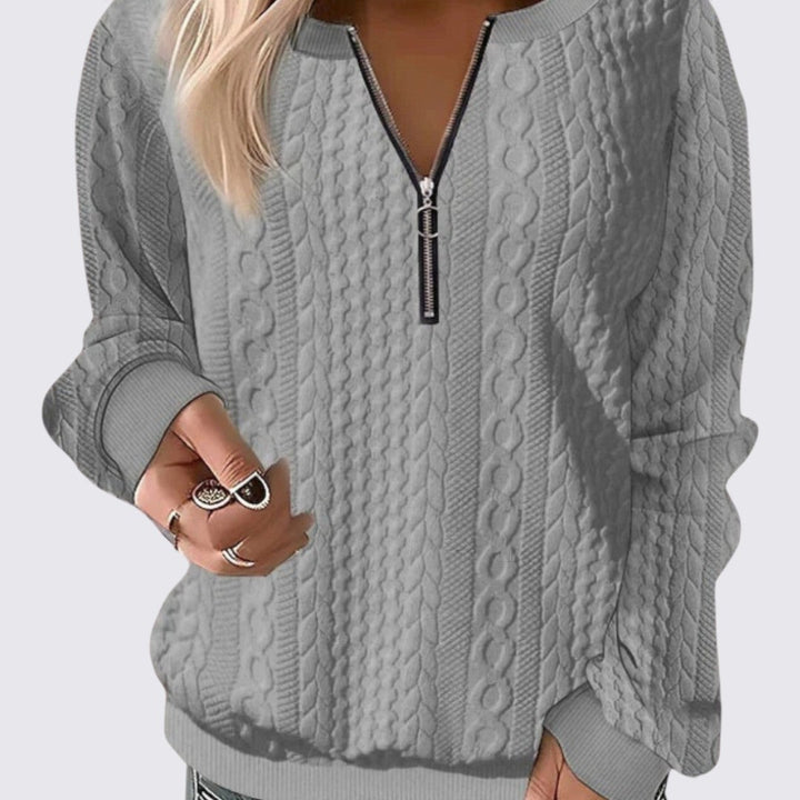 Grey quarter zip cable knit sweater with ribbed cuffs and hem