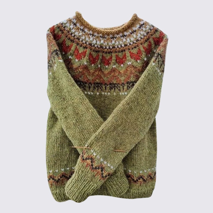 Folded olive green sweater with a red and cream Fair Isle patterned yoke