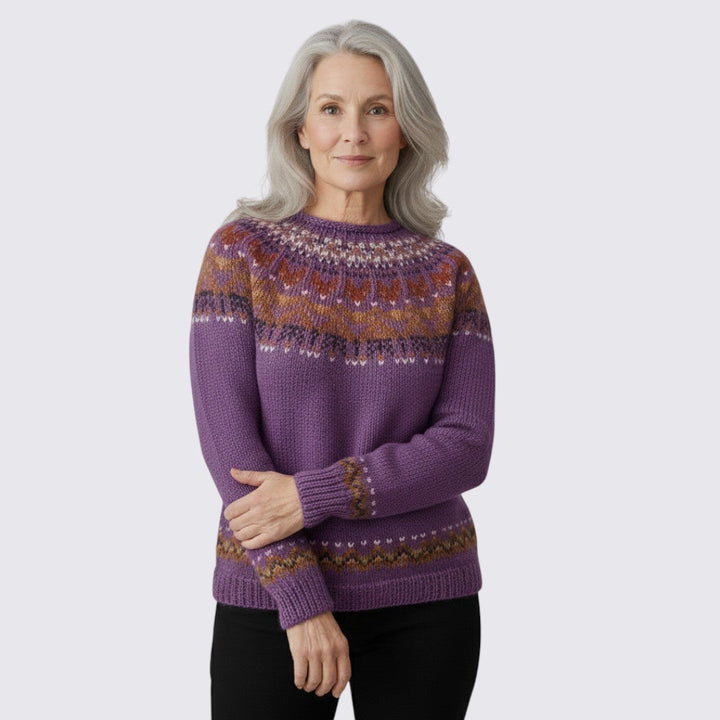 Front view of the purple Fair Isle yoke sweater worn with black trousers