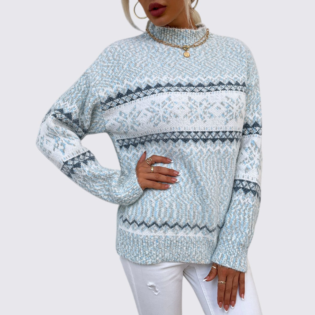 Light blue mock neck sweater with white nordic snowflake stripes, worn with white jeans