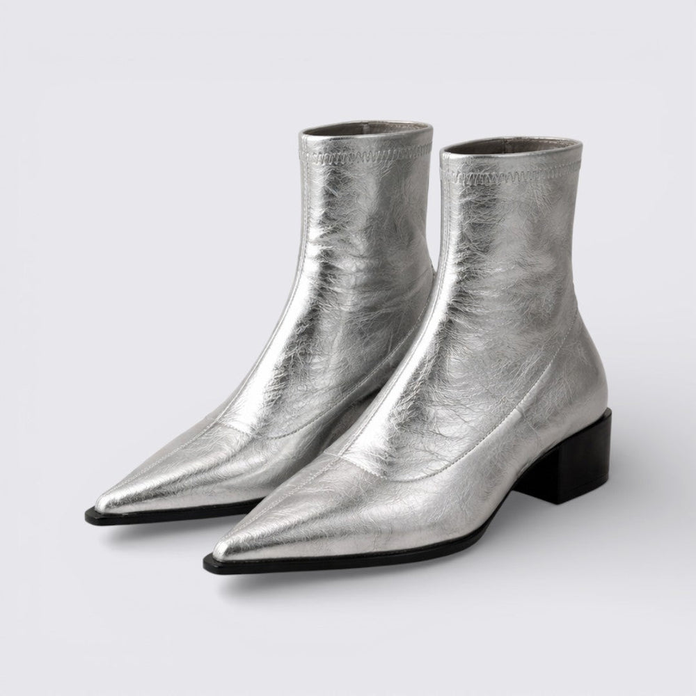 Silver metallic ankle boots with pointed toe and low block heel, angled pair