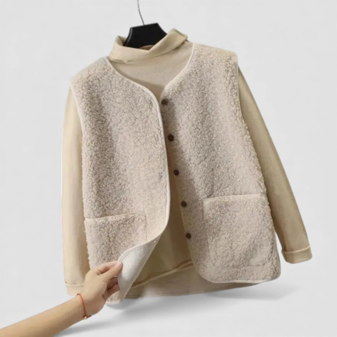 Cream teddy fleece vest with front buttons and patch pockets, shown on a hanger