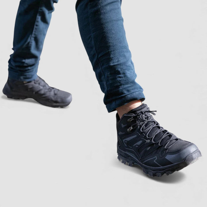 Black lace up hiking shoes with grippy lug soles worn with jeans while walking