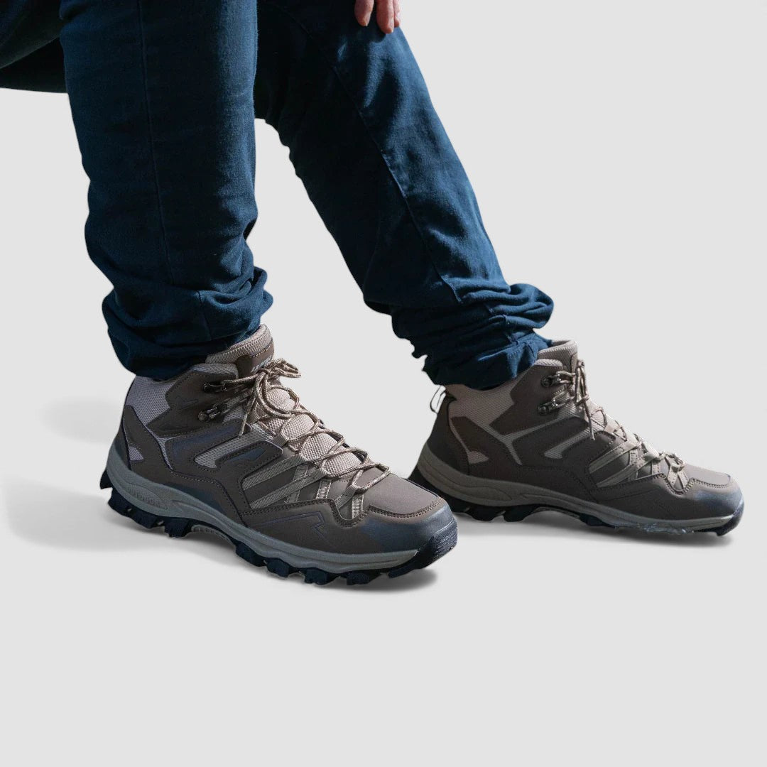 Grey lace up hiking shoes with a padded ankle collar worn with dark blue jeans