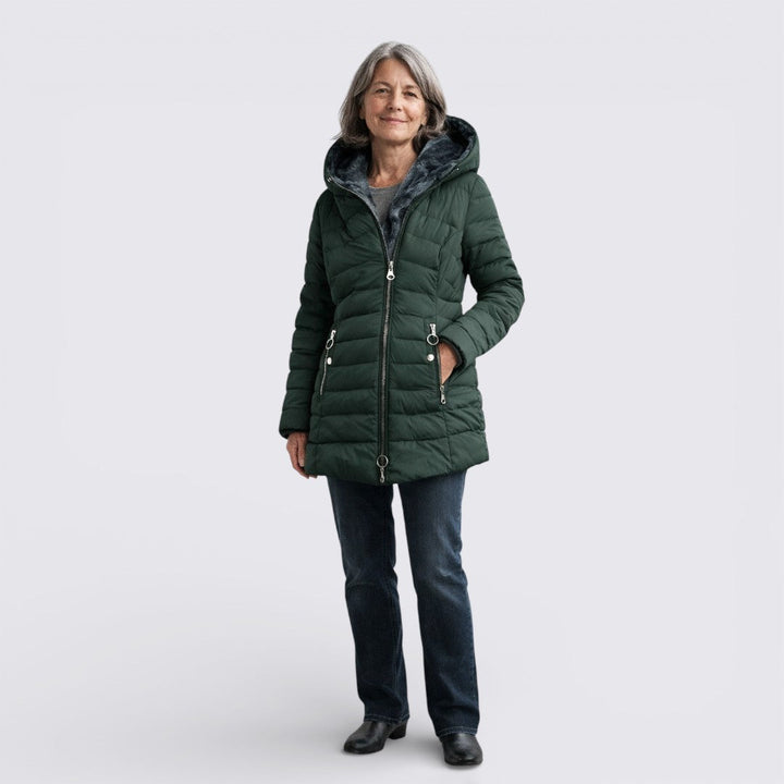 Woman wearing a dark green quilted coat with a faux fur lined hood