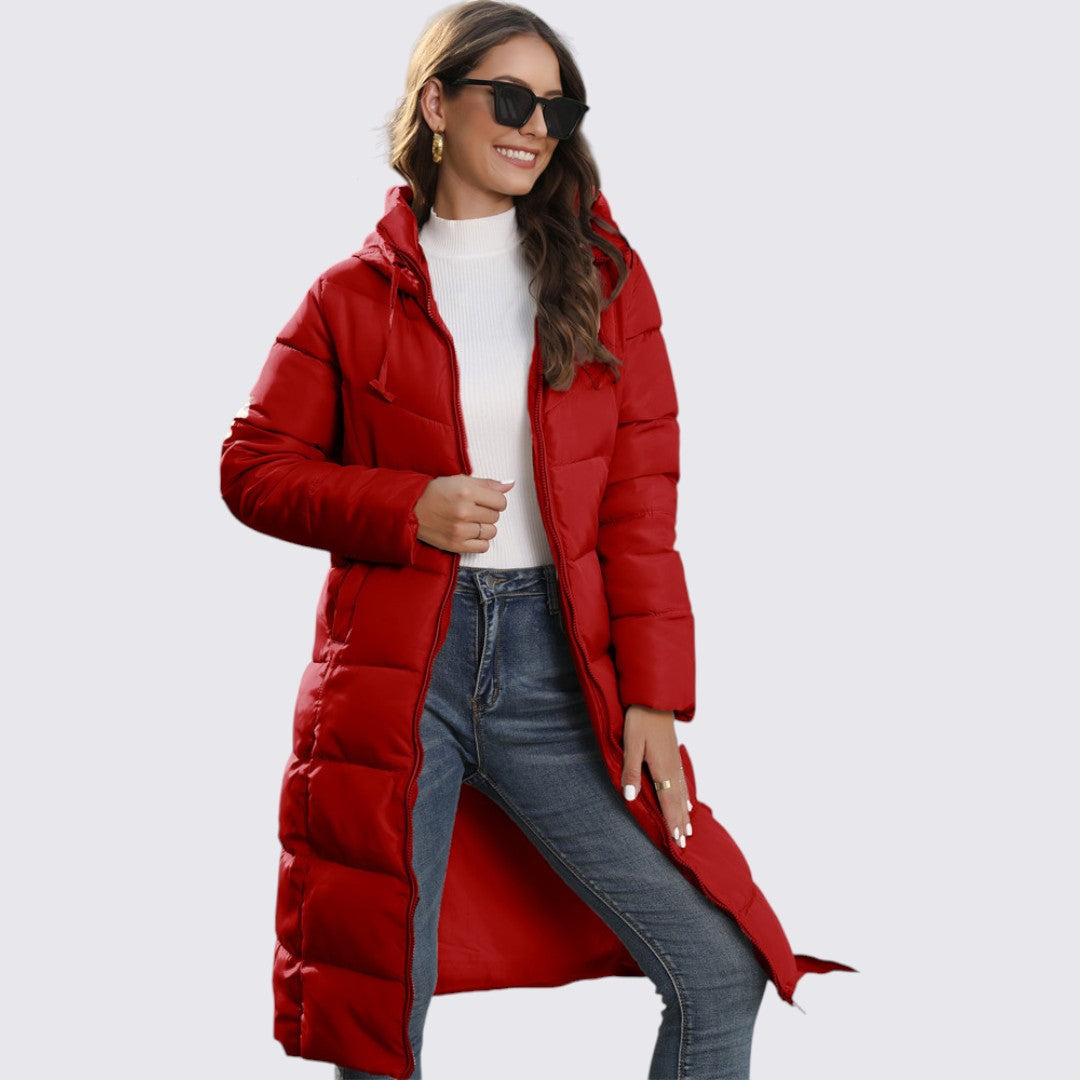 Red long quilted hooded puffer coat worn open over jeans, front side view