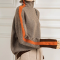 Side view of a brown herringbone turtleneck sweater with an orange stripe down the sleeve