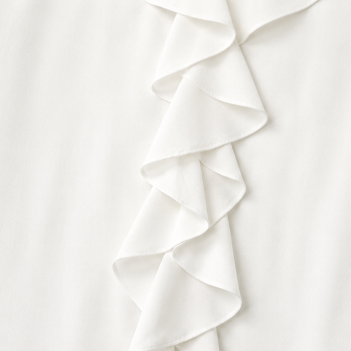 Close up of the cascading ruffle placket on a white blouse