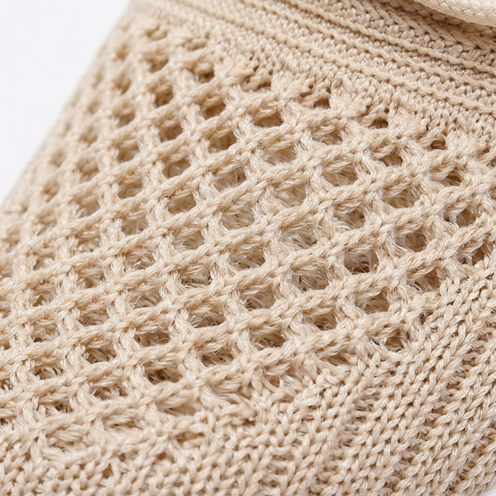 Close-up of the open beige knit weave on the sneaker upper