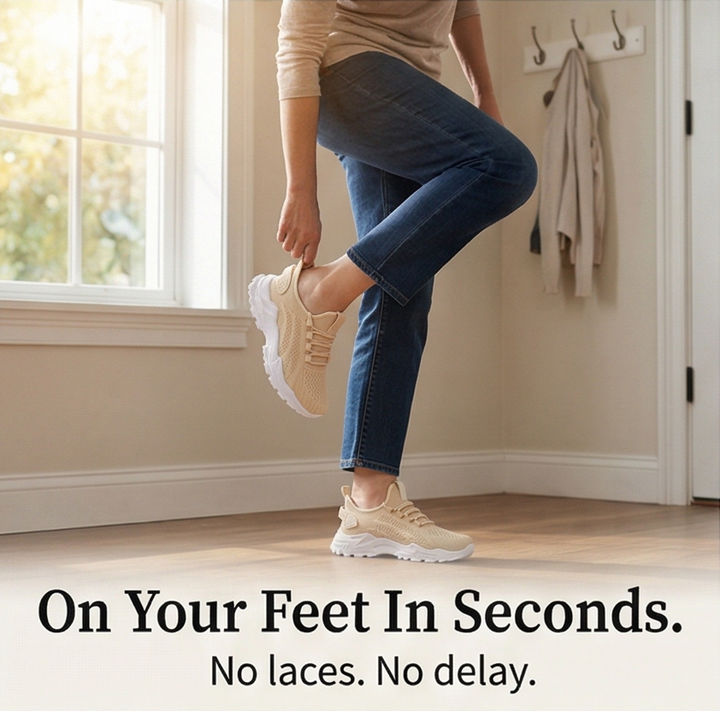 Woman slipping on a beige knit sneaker in a hallway