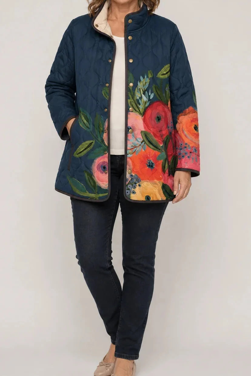 Navy quilted jacket with a bright floral print and snap front