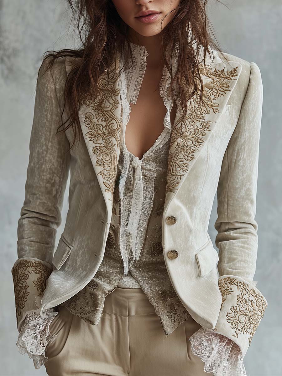 Ivory blazer with embroidered lapels and cuffs over a ruffled blouse