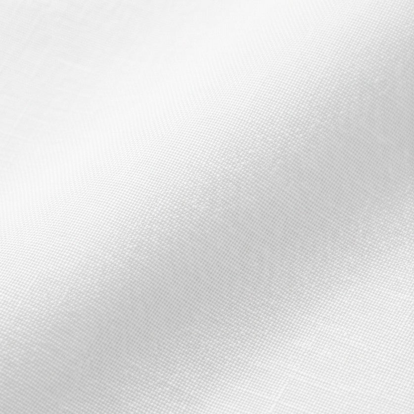 Close-up of the fine linen-look weave of the white blouse