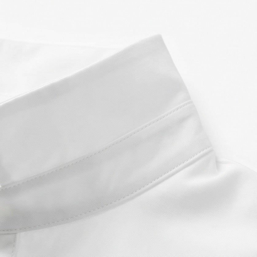 Close-up of the white blouse cuff with its stitched edge