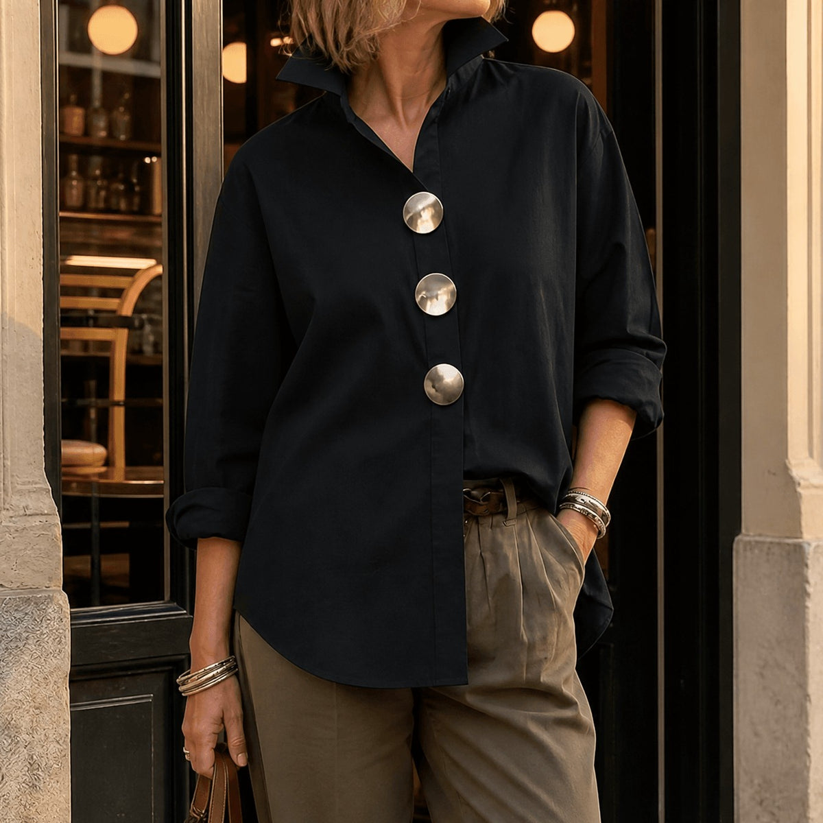 Black asymmetric button front blouse with oversized round buttons, front view