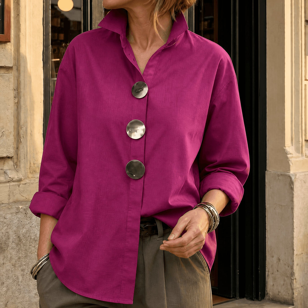 Fuchsia asymmetric button front blouse with oversized round buttons, front view