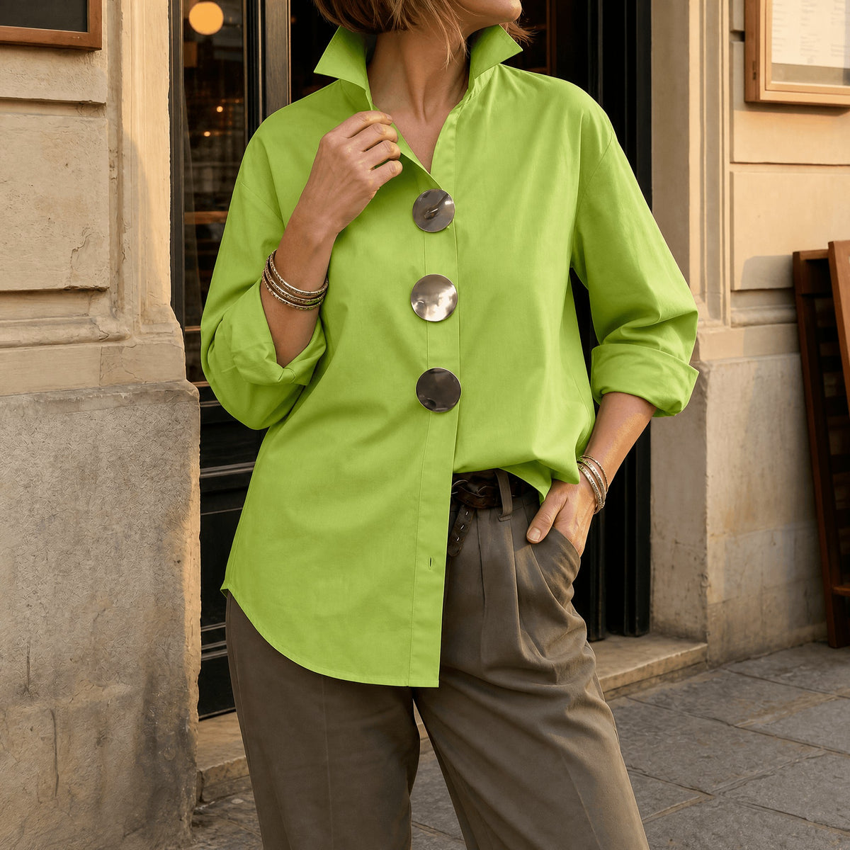 Lime green asymmetric button front blouse with oversized round buttons, front view