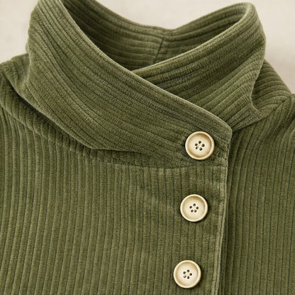 Close-up of the funnel collar and round buttons on the olive green corduroy top