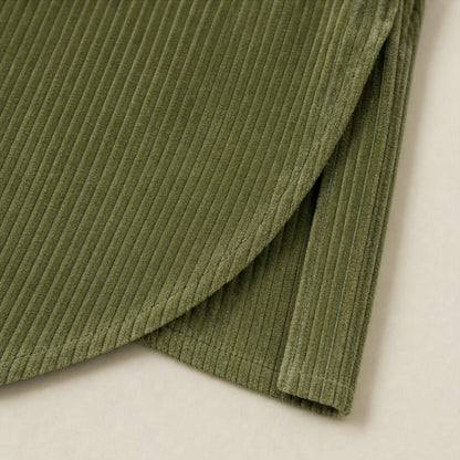 Close-up of the curved crossover hem of the corduroy top