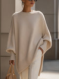 Beige oversized poncho sweater with an asymmetric hem, front view