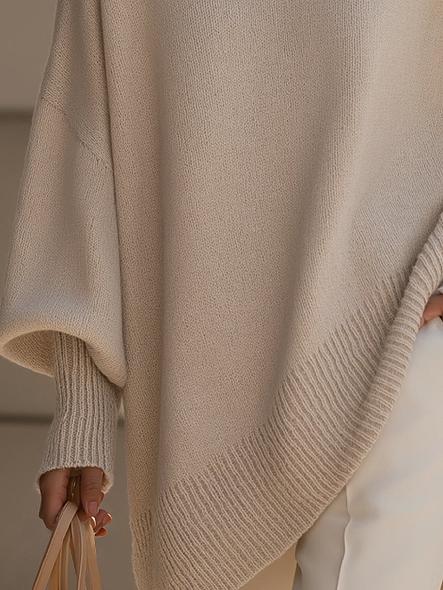 Close-up of the ribbed cuff and slanted ribbed hem of the beige sweater