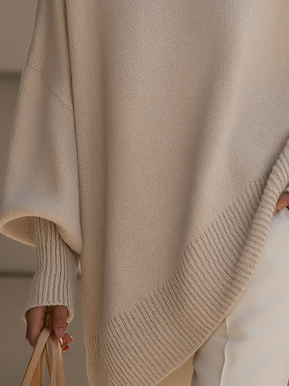 Close-up of the ribbed cuff and slanted ribbed hem of the beige sweater