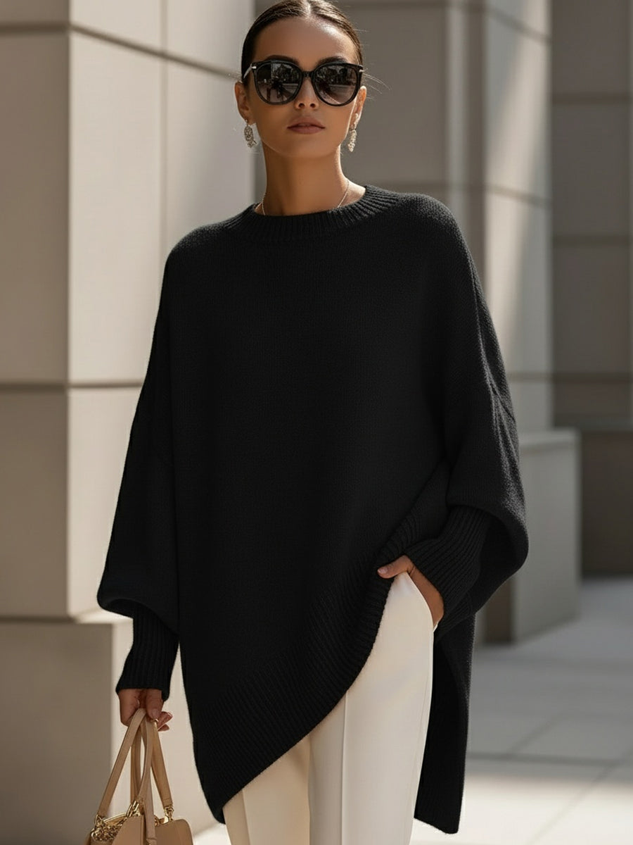Black oversized poncho sweater with an asymmetric hem, front view