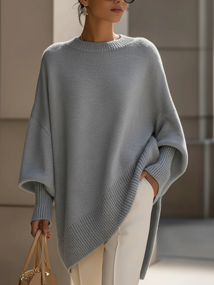 Gray oversized poncho sweater with an asymmetric hem, front view