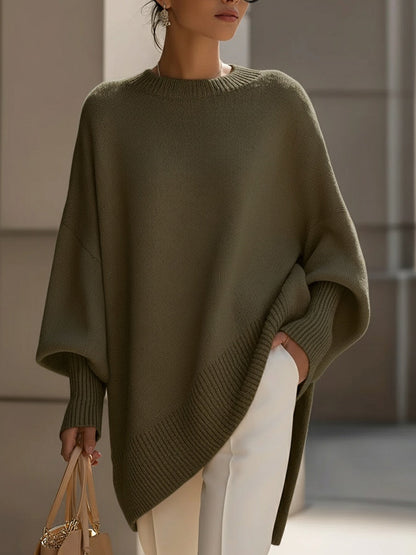 Olive green oversized poncho sweater with an asymmetric hem, front view
