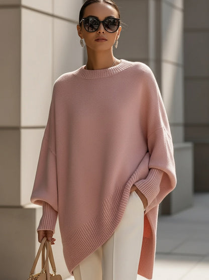 Pink oversized poncho sweater with an asymmetric hem, front view
