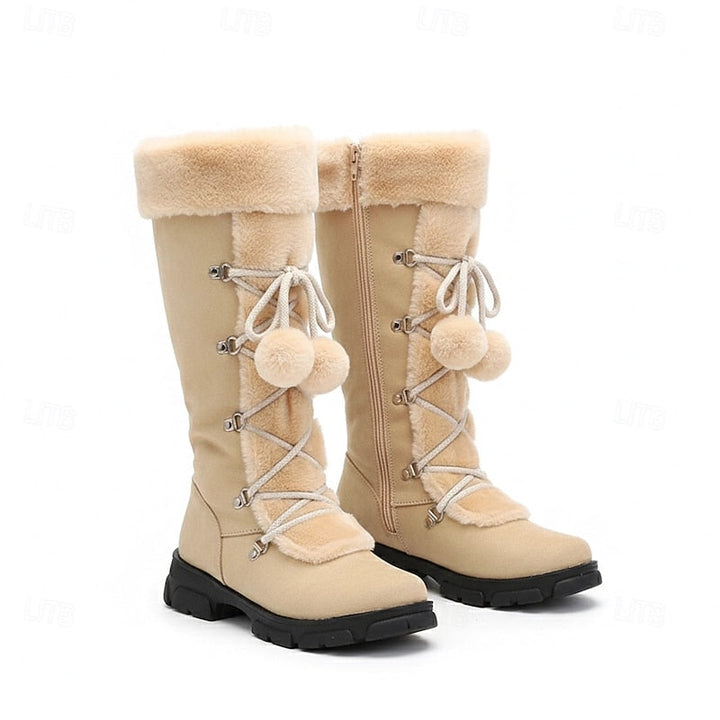 Beige mid calf boots with a cream fur cuff and pom laces