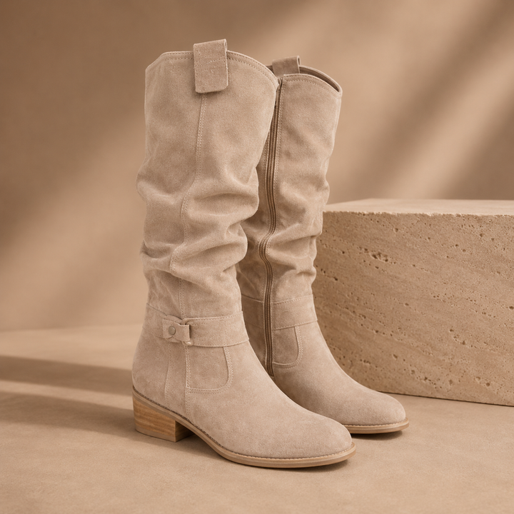 Beige suede knee high boots with a slouched shaft