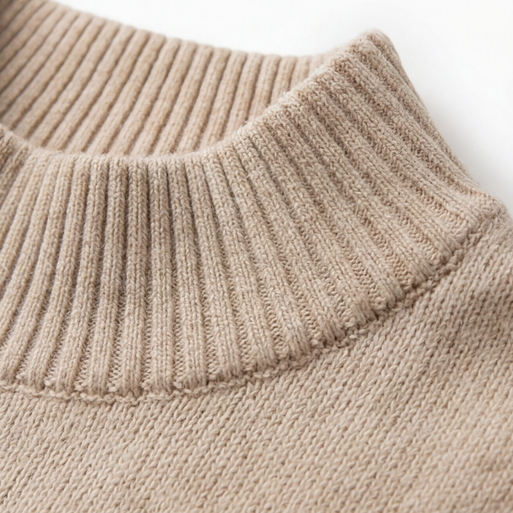 Close-up of the beige sweater's ribbed funnel collar and knit texture