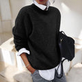 Black drop shoulder sweater layered over a white shirt