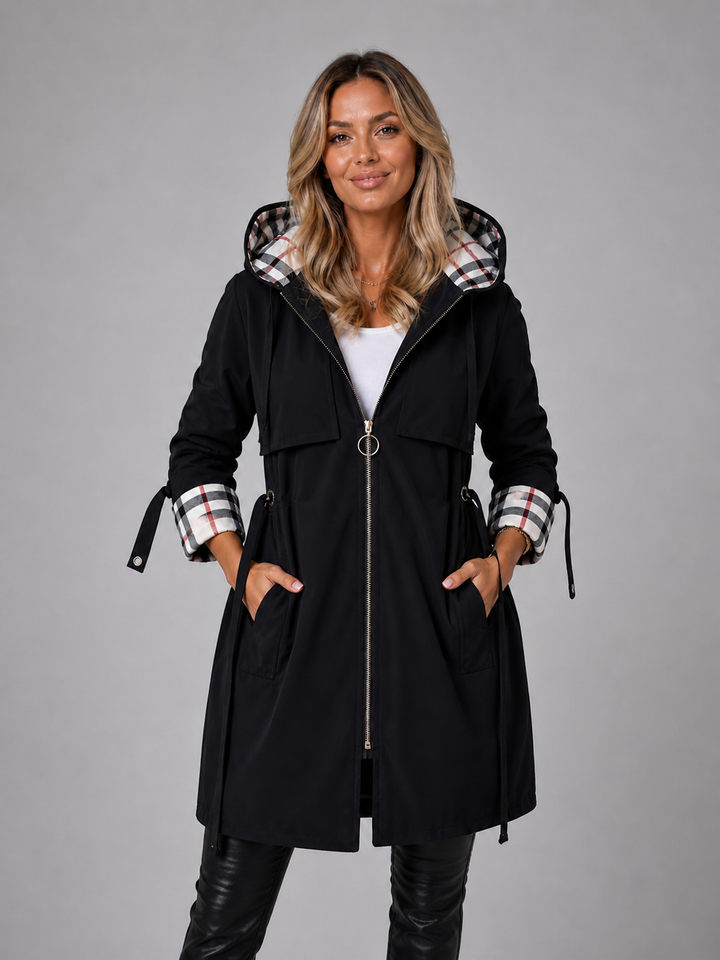 Black hooded parka with a check lined hood, worn zipped