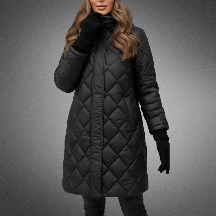 Black diamond quilted longline coat worn with gloves, front view