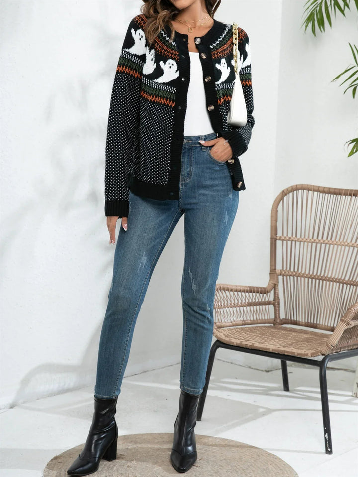 Black button cardigan with a white ghost yoke pattern worn open over jeans