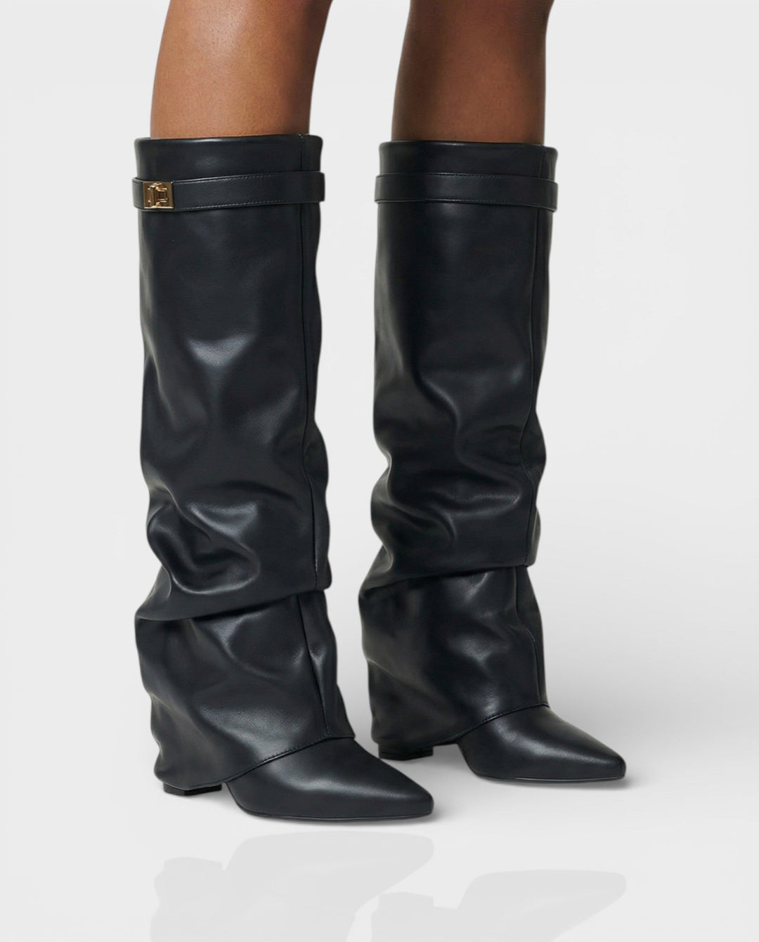 Black leather foldover knee boots worn with bare legs