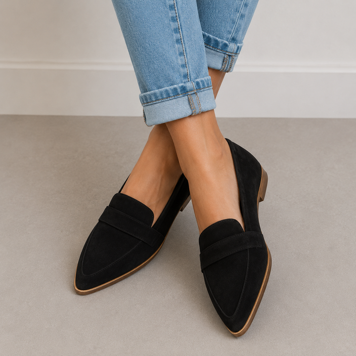 Black suede pointed toe loafers worn with cropped jeans